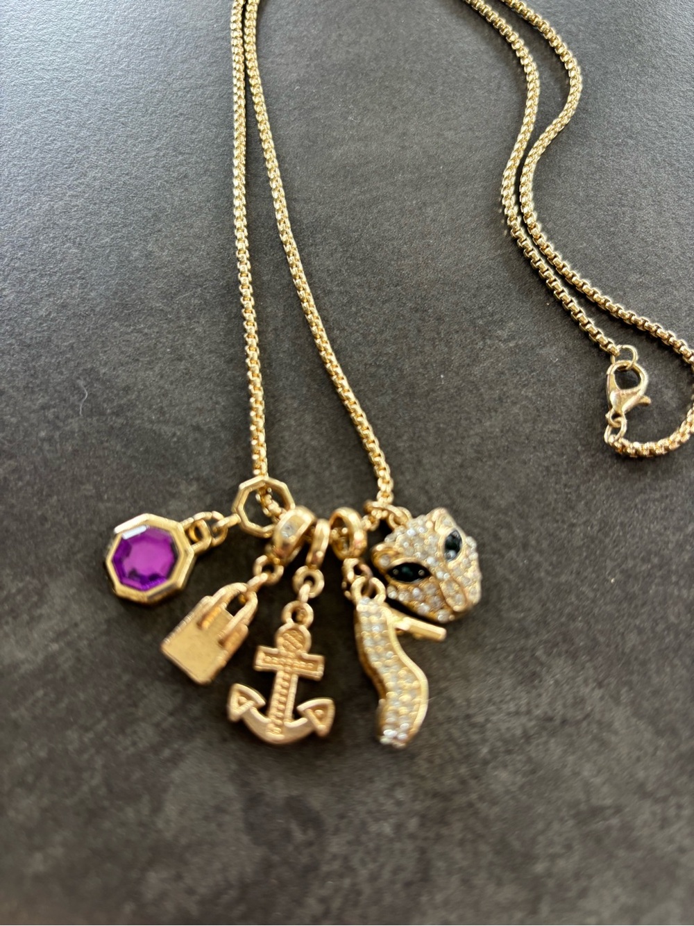 Gold-Tone Multi-Charm Necklace with Purple Crystal Accent